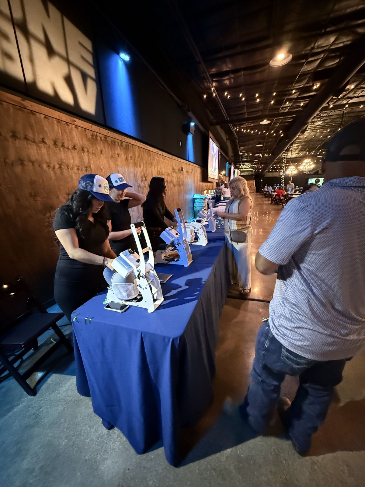 Guests watching custom merch get printed live at a Portland event